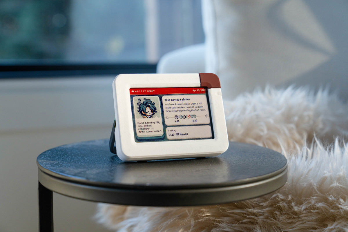 Inku e-ink desk calendar Small size in Coffee colorway displayed in a lifestyle setting with warm brown tones and daily calendar on 4-inch e-paper screen